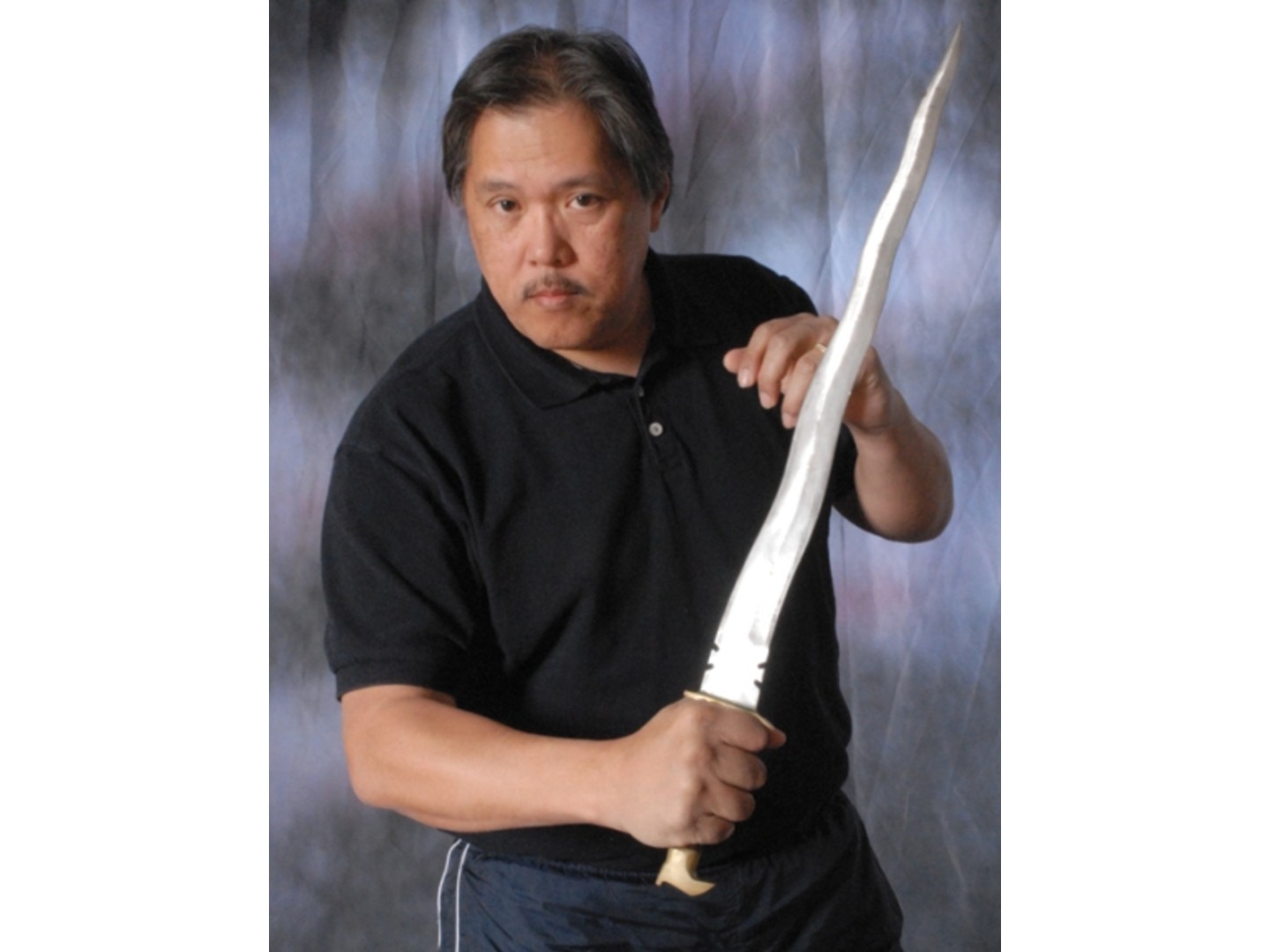 The late SGM Rene Latosa, founder of Latosa Escrima, holding a kris blade